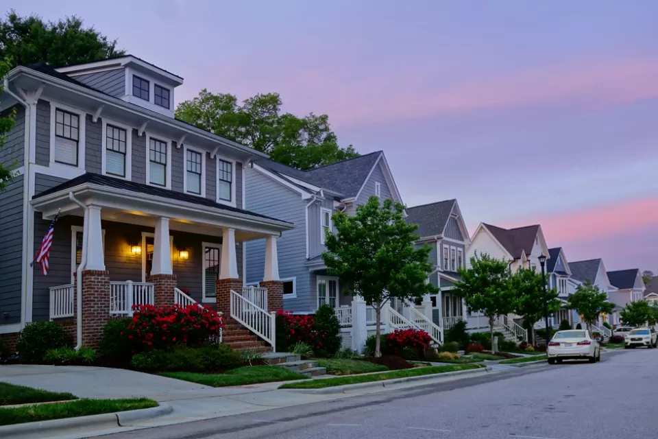 View of houses on small street in Raleigh, North Carolina against a sunset sky